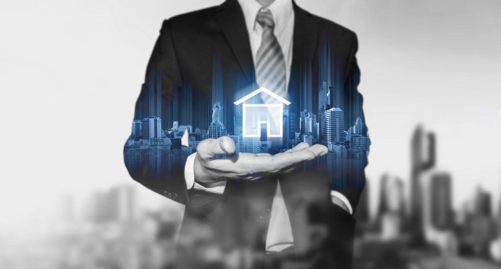 Businessman Holding Modern Buildings (hologram)