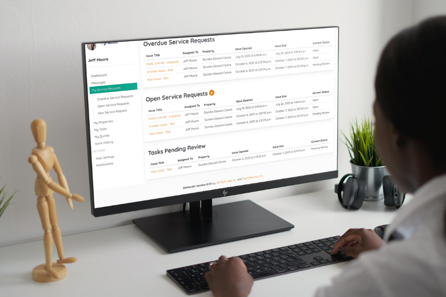 Woman at Desktop Computer with Service Requests Screen Showing