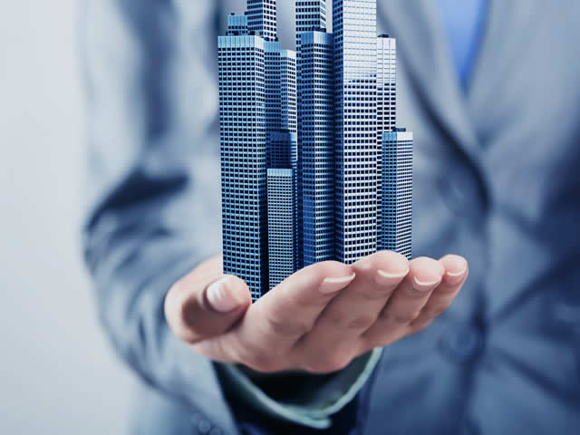 Hand Holding Building