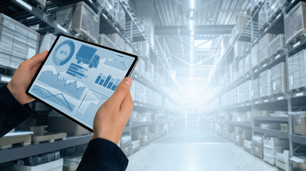 Man in Warehouse Holding Tablet with Graphical Report on Screen