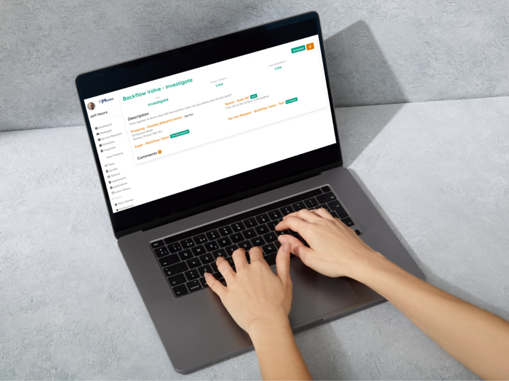 Hands on Laptop showing Rental Request Details Screen