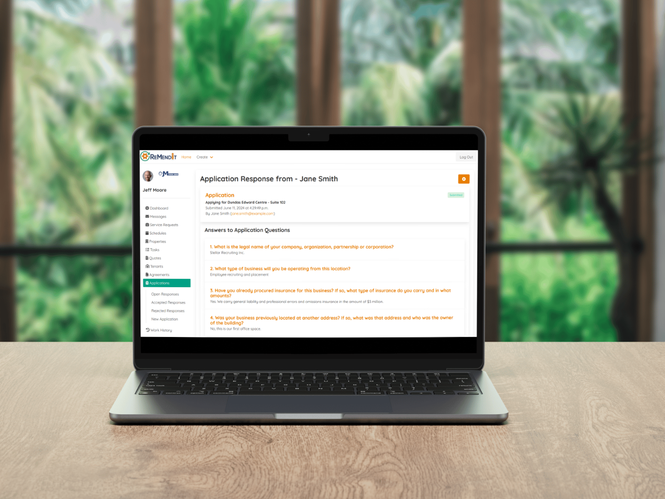 Laptop on Desk showing Application Response Details Screen